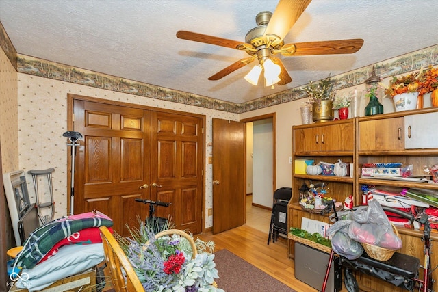 8111 Timberwood Dr, Plainfield, IN 46168 - interior space featuring a textured ceiling, light wood-type flooring, and a ceiling fan