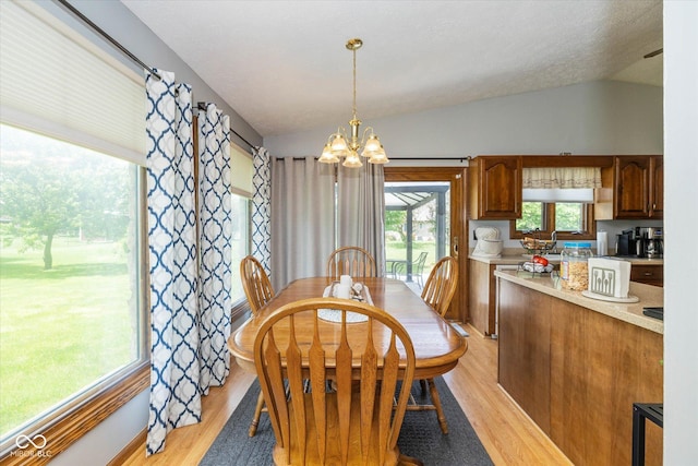 8111 Timberwood Dr, Plainfield, IN 46168 - dining room with a chandelier, light wood-style floors, and vaulted ceiling