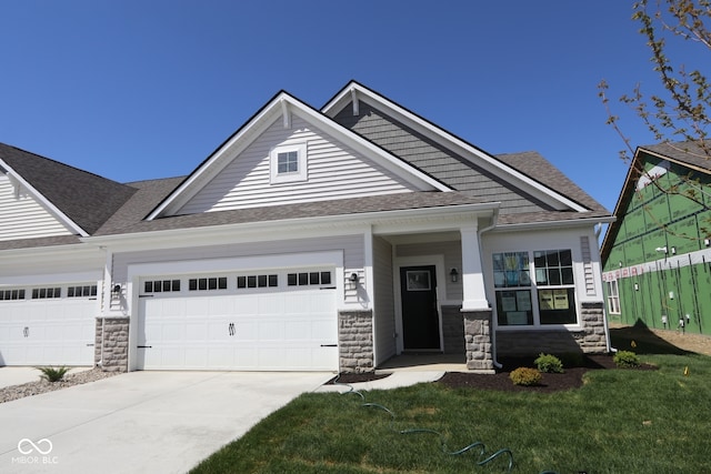 10544 Maidenhair Dr, Indianapolis, IN 46239 - craftsman-style house featuring concrete driveway, stone siding, roof with shingles, and a garage