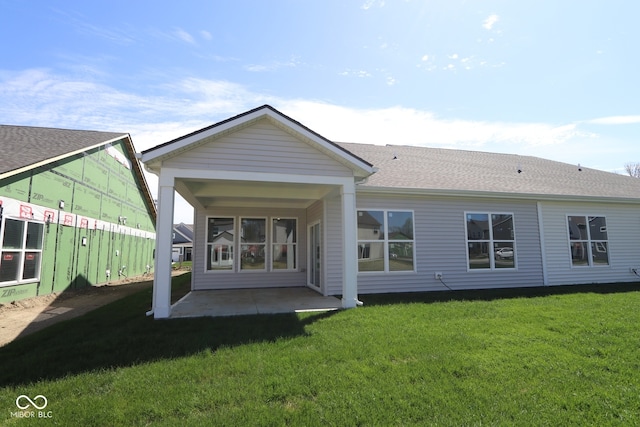 10544 Maidenhair Dr, Indianapolis, IN 46239 - rear view of house with a lawn, a patio area, and roof with shingles
