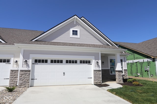 10544 Maidenhair Dr, Indianapolis, IN 46239 - craftsman-style house featuring concrete driveway, stone siding, and a shingled roof