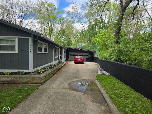 view of side of home with concrete driveway