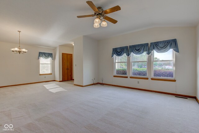 carpeted empty room with plenty of natural light, a chandelier, baseboards, and lofted ceiling