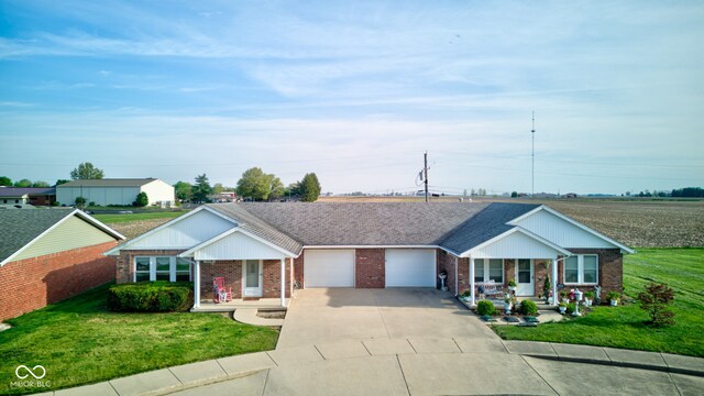 ranch-style home featuring brick siding, an attached garage, a porch, and a front lawn