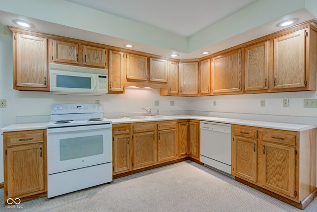 kitchen with white appliances, a sink, light countertops, recessed lighting, and light colored carpet