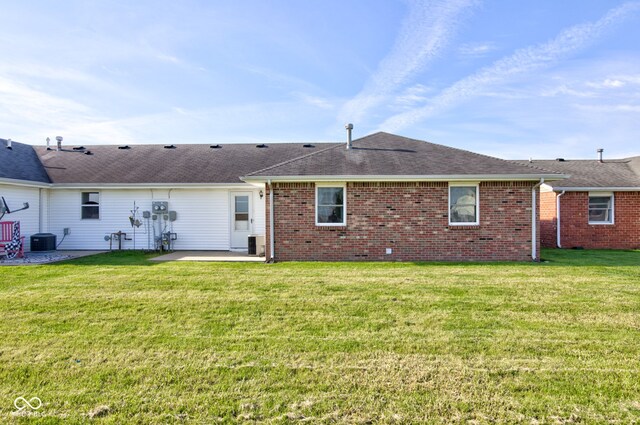 back of house featuring a patio area, cooling unit, a yard, brick siding, and a shingled roof