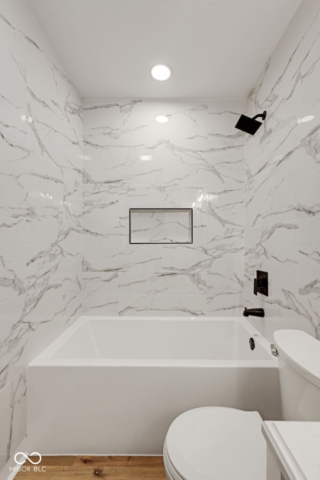 bathroom featuring shower / bathing tub combination, toilet, wood finished floors, vanity, and recessed lighting