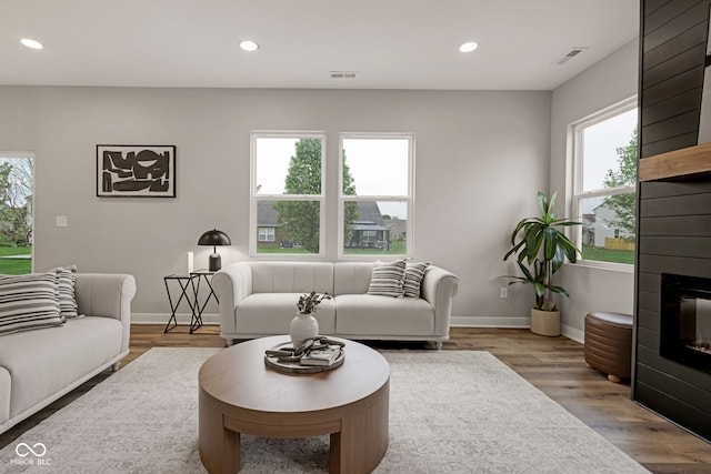 living room featuring recessed lighting, visible vents, and wood finished floors