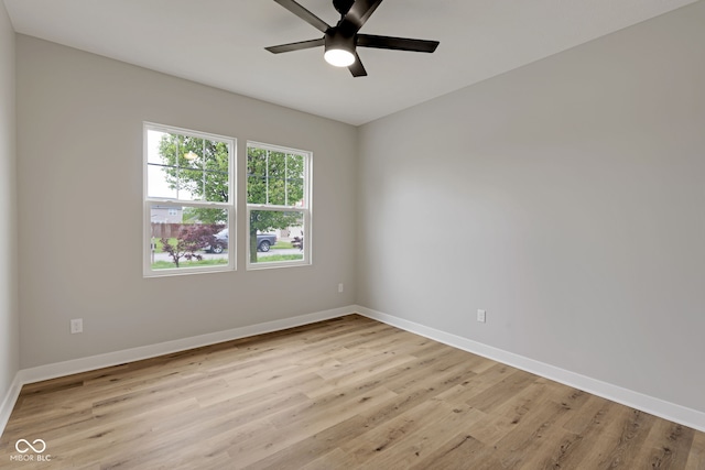spare room with ceiling fan, baseboards, and light wood finished floors