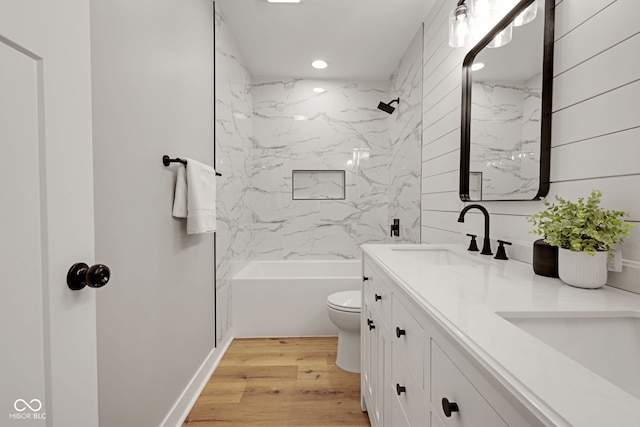 bathroom with a sink, double vanity, toilet, and recessed lighting