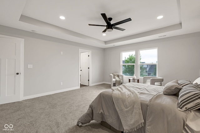 bedroom featuring recessed lighting, carpet, baseboards, visible vents, and a raised ceiling