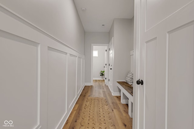 mudroom with baseboards and light wood-style floors