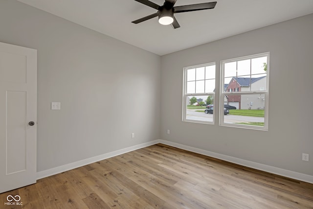 unfurnished room featuring baseboards, light wood-style flooring, and ceiling fan