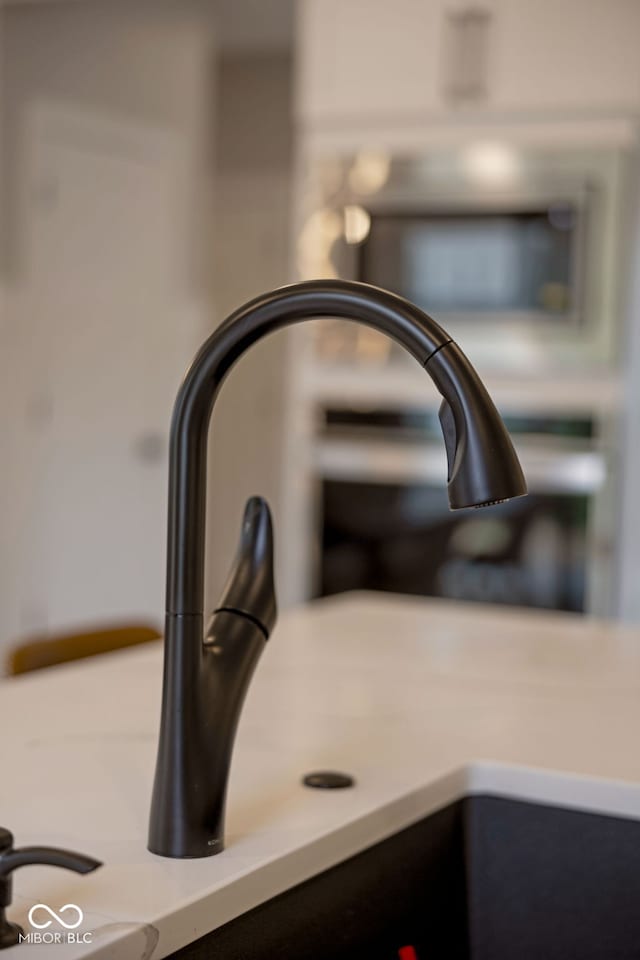 details featuring light countertops and a sink