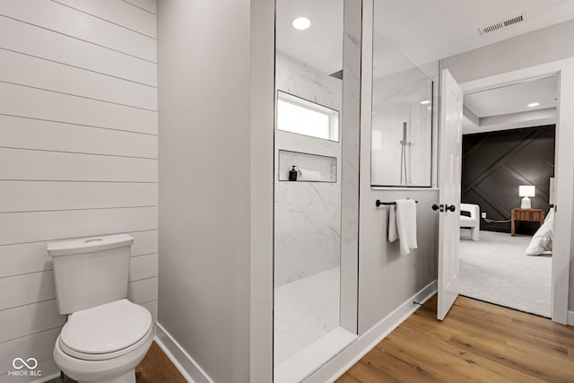 full bathroom featuring recessed lighting, toilet, visible vents, wood finished floors, and a marble finish shower