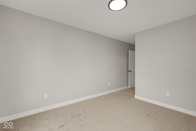unfurnished room featuring baseboards and carpet floors