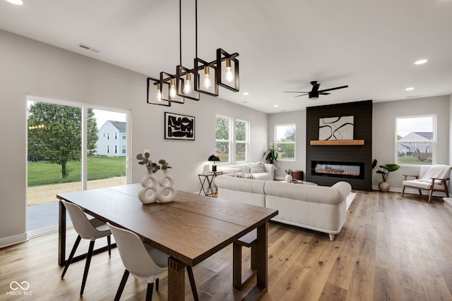 dining space with light wood finished floors, visible vents, and recessed lighting