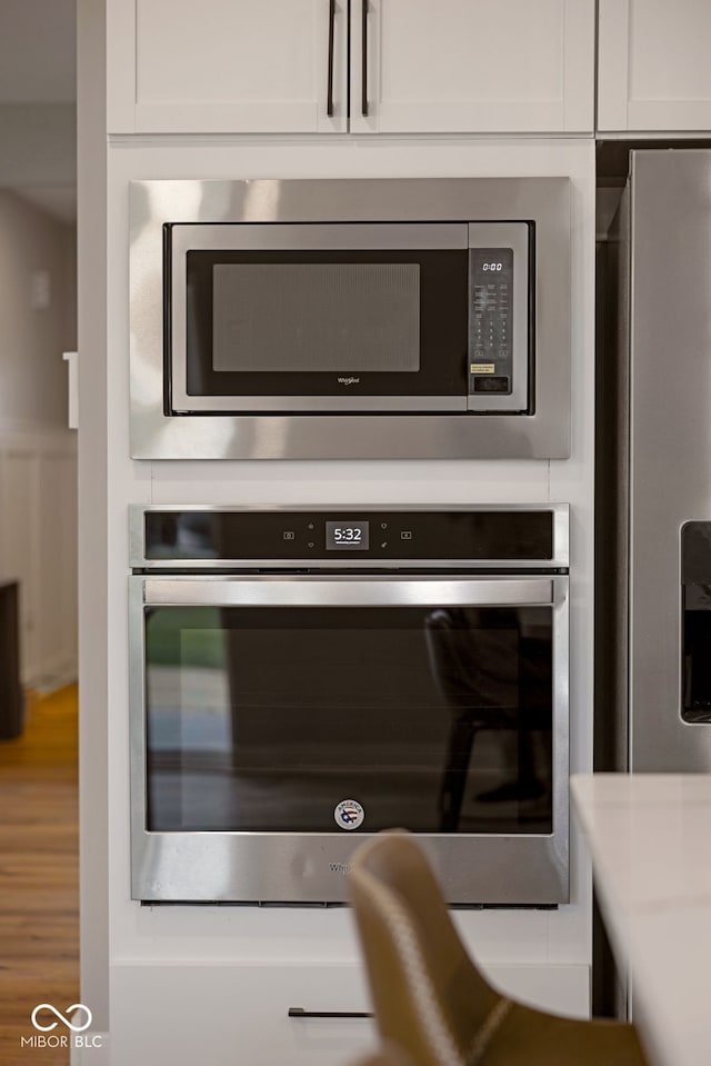 interior details featuring light countertops, white cabinetry, and stainless steel appliances