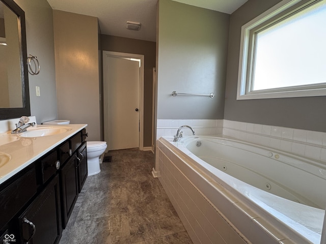 2725 Falcon Ct, Seymour, IN 47274 - full bathroom with a jetted tub, toilet, double vanity, and baseboards
