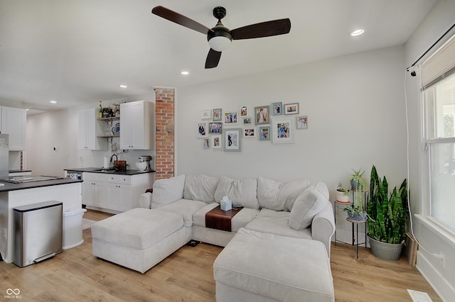 living room with a ceiling fan, light wood finished floors, and recessed lighting
