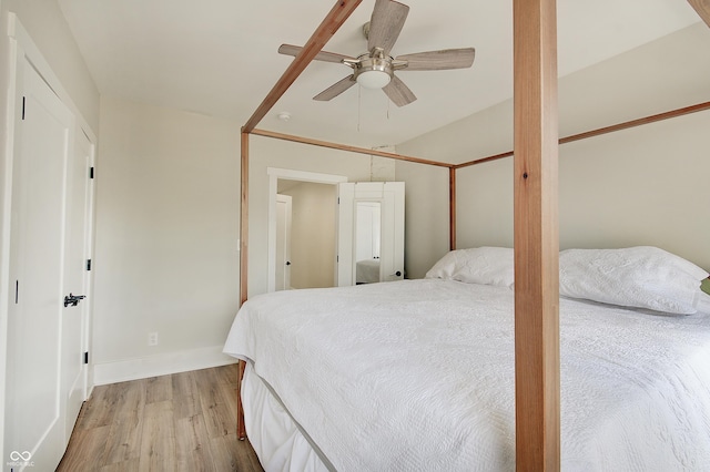 bedroom featuring light wood-type flooring, baseboards, and ceiling fan