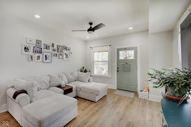 living room with baseboards, ceiling fan, light wood-style floors, and recessed lighting