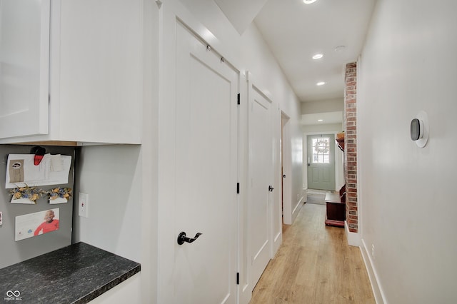 hall with light wood-style flooring, recessed lighting, and baseboards