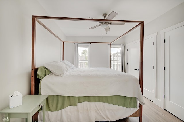 bedroom with light wood-style flooring and ceiling fan