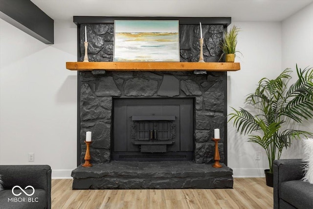 6682 English Dr, Avon, IN 46123 - detailed view of wood finished floors, baseboards, and a fireplace