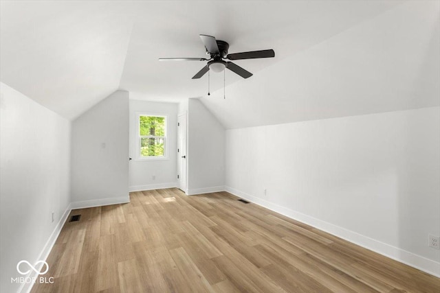 6682 English Dr, Avon, IN 46123 - additional living space with light wood-style floors, vaulted ceiling, ceiling fan, and baseboards