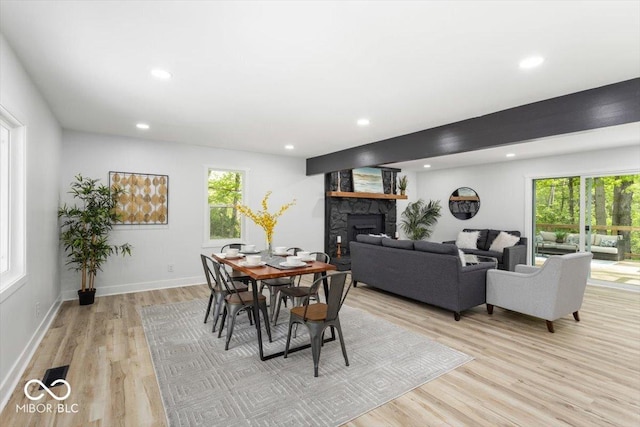 6682 English Dr, Avon, IN 46123 - dining room with a fireplace, plenty of natural light, light wood-style flooring, recessed lighting, and baseboards