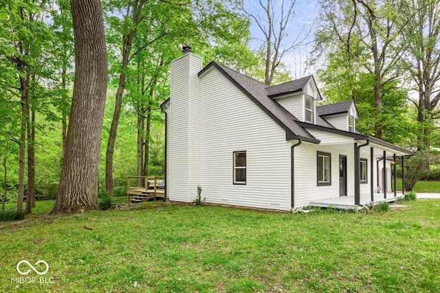 6682 English Dr, Avon, IN 46123 - view of home's exterior featuring a chimney, covered porch, roof with shingles, and a lawn