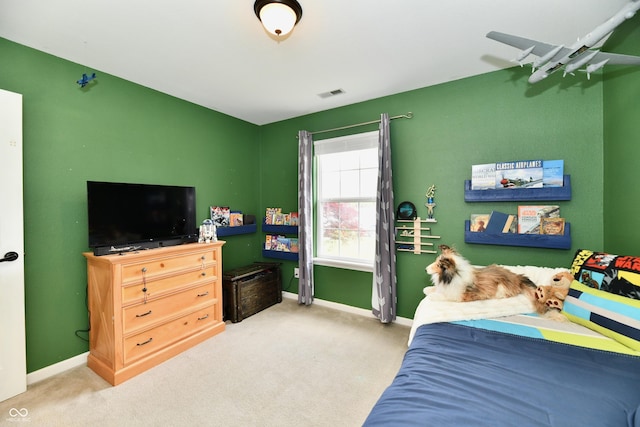 carpeted bedroom featuring baseboards and visible vents