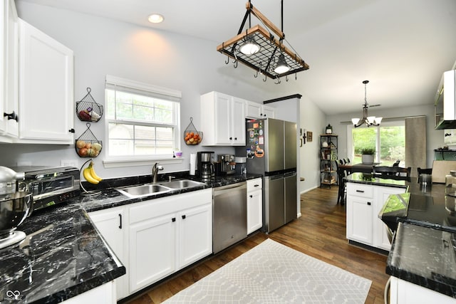 kitchen with a sink, stainless steel appliances, and white cabinetry