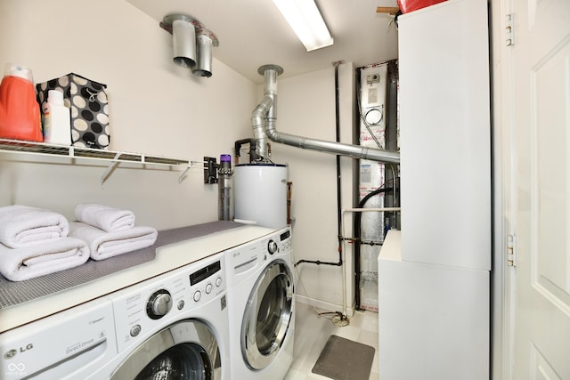 laundry area featuring independent washer and dryer, water heater, and laundry area