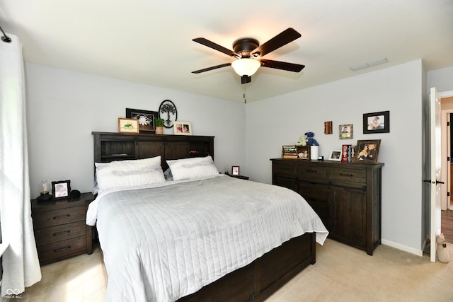 bedroom with light carpet, visible vents, and ceiling fan