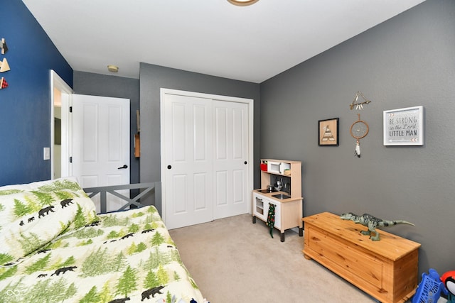 bedroom featuring light carpet and a closet