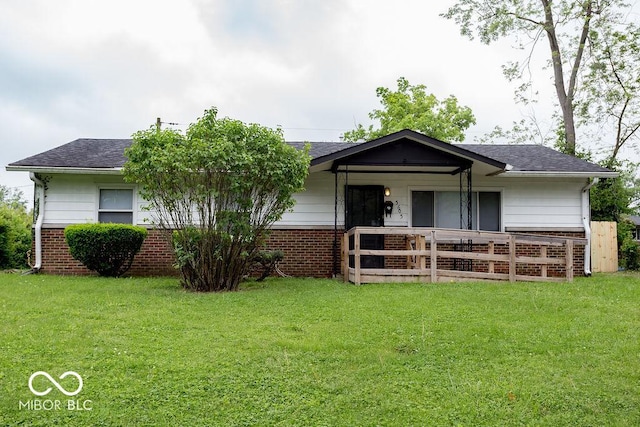 5605 Glencoe St, Indianapolis, IN 46226 - view of front of home featuring brick siding, a front lawn, covered porch, and roof with shingles