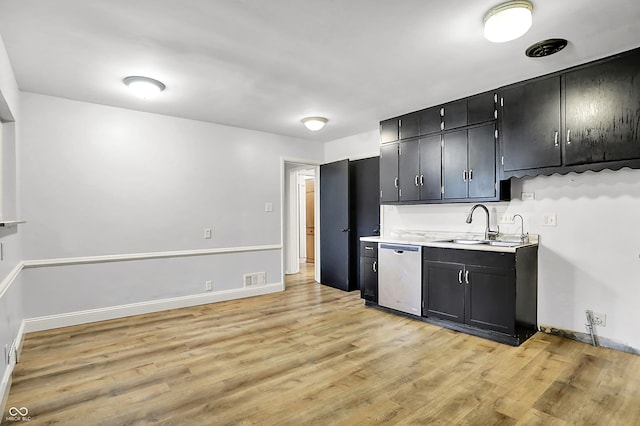3975 Denwood Dr, Indianapolis, IN 46226 - kitchen featuring dishwasher, dark cabinetry, light wood finished floors, and a sink