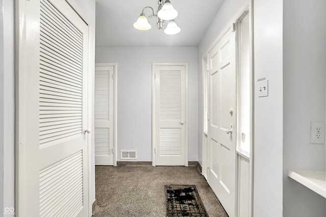 3975 Denwood Dr, Indianapolis, IN 46226 - hallway with dark colored carpet, a chandelier, and baseboards