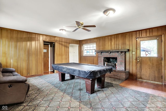 3975 Denwood Dr, Indianapolis, IN 46226 - rec room featuring ceiling fan, billiards, a brick fireplace, wood finished floors, and wooden walls