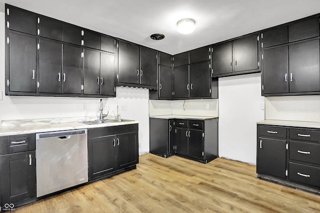 3975 Denwood Dr, Indianapolis, IN 46226 - kitchen featuring dishwasher, a sink, dark cabinets, and light wood-style floors
