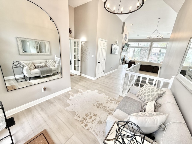 14035 Stone Key Way, Fishers, IN 46037 - living room with a chandelier, wood finished floors, high vaulted ceiling, and baseboards