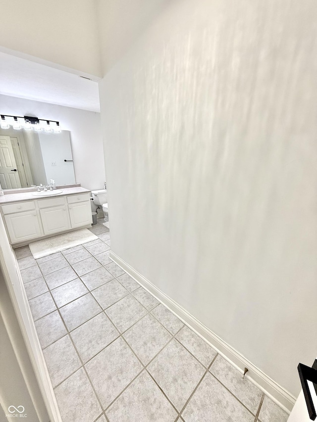 14035 Stone Key Way, Fishers, IN 46037 - bathroom with tile patterned floors, vanity, toilet, and baseboards