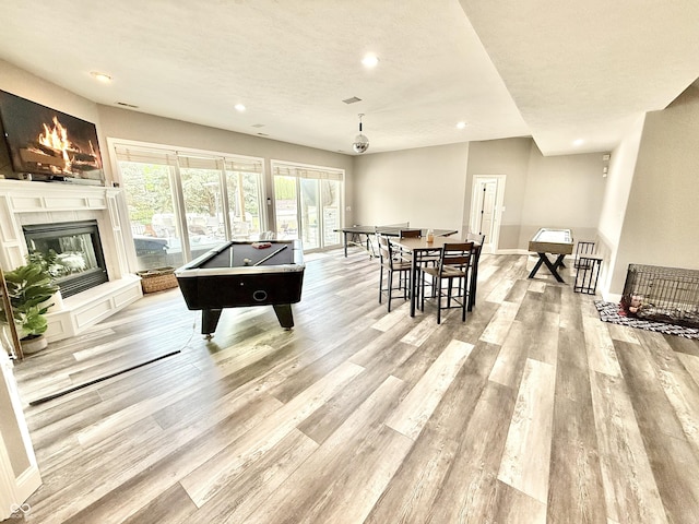 14035 Stone Key Way, Fishers, IN 46037 - recreation room featuring recessed lighting, light wood-style floors, pool table, a glass covered fireplace, and baseboards
