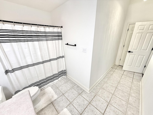 14035 Stone Key Way, Fishers, IN 46037 - full bathroom with tile patterned flooring, toilet, baseboards, and a shower with shower curtain