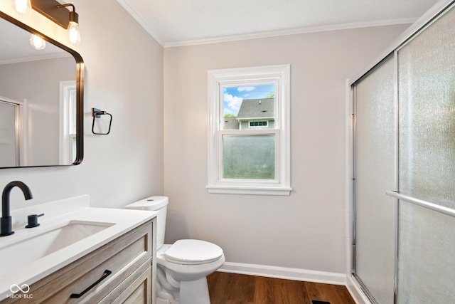 bathroom featuring crown molding, wood finished floors, toilet, an enclosed shower, and vanity