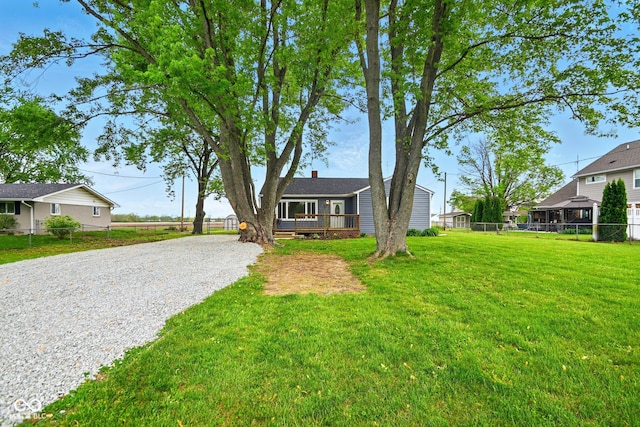 view of front facade featuring driveway and a deck