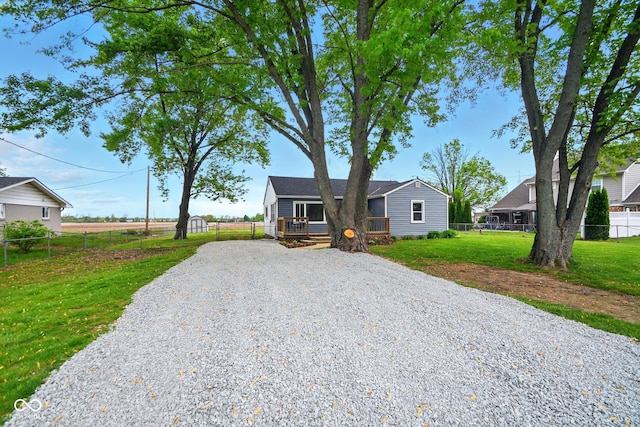 view of front facade featuring driveway and a deck