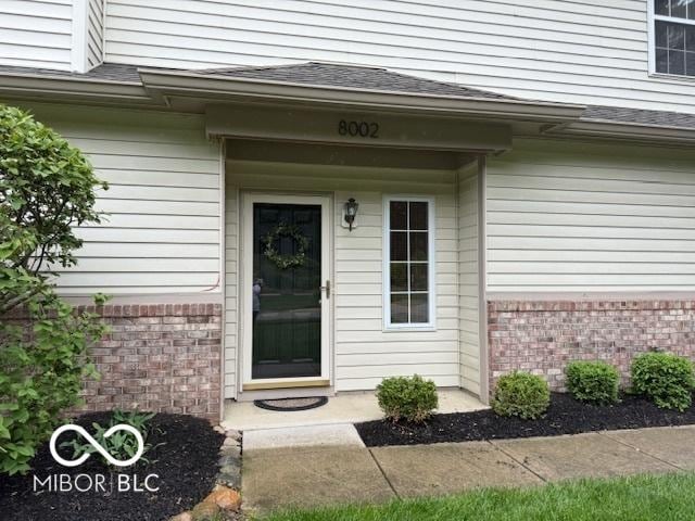 8002 Windham Lake Way Unit 33, Indianapolis, IN 46214 - property entrance featuring brick siding and roof with shingles